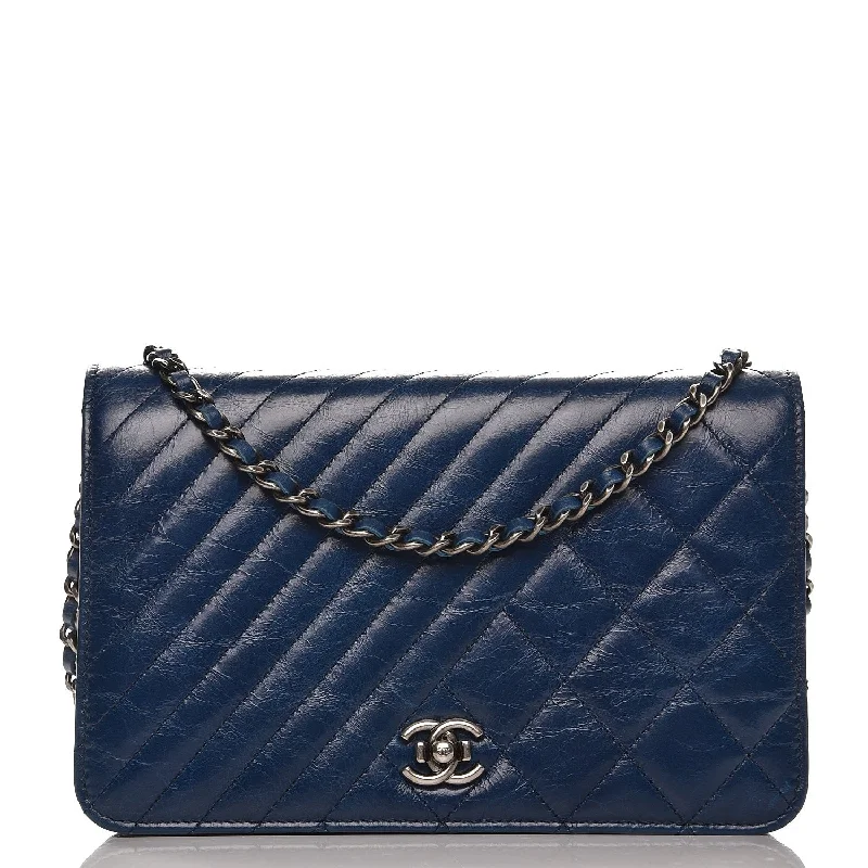 CHANEL bags with gold-tone chain straps -CHANEL Glazed Calfskin Quilted Coco Boy Wallet On Chain WOC